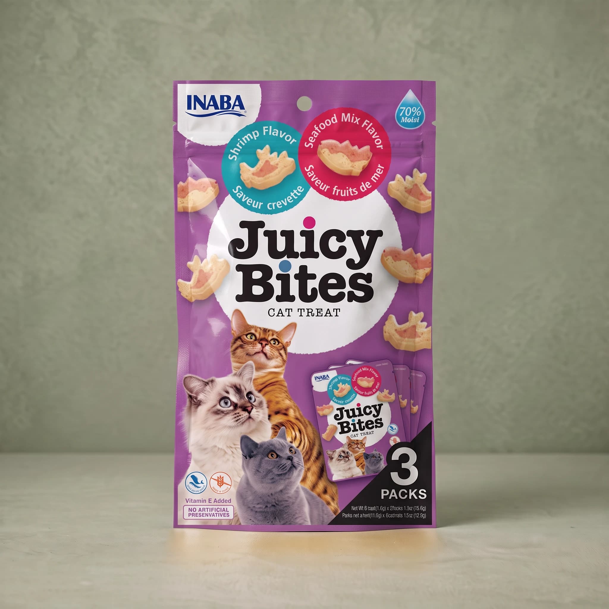 Purple INABA Juicy Bites cat treat pouch in the Shrimp and Seafood Mix flavours, with a teal 'Shrimp Flavor' roundel showing a shrimp-shaped treat and a red 'Seafood Mix Flavor' roundel showing a fish-shaped treat, a '70% Moist' droplet flash, photographs of three cats, and a '3 PACKS' panel.