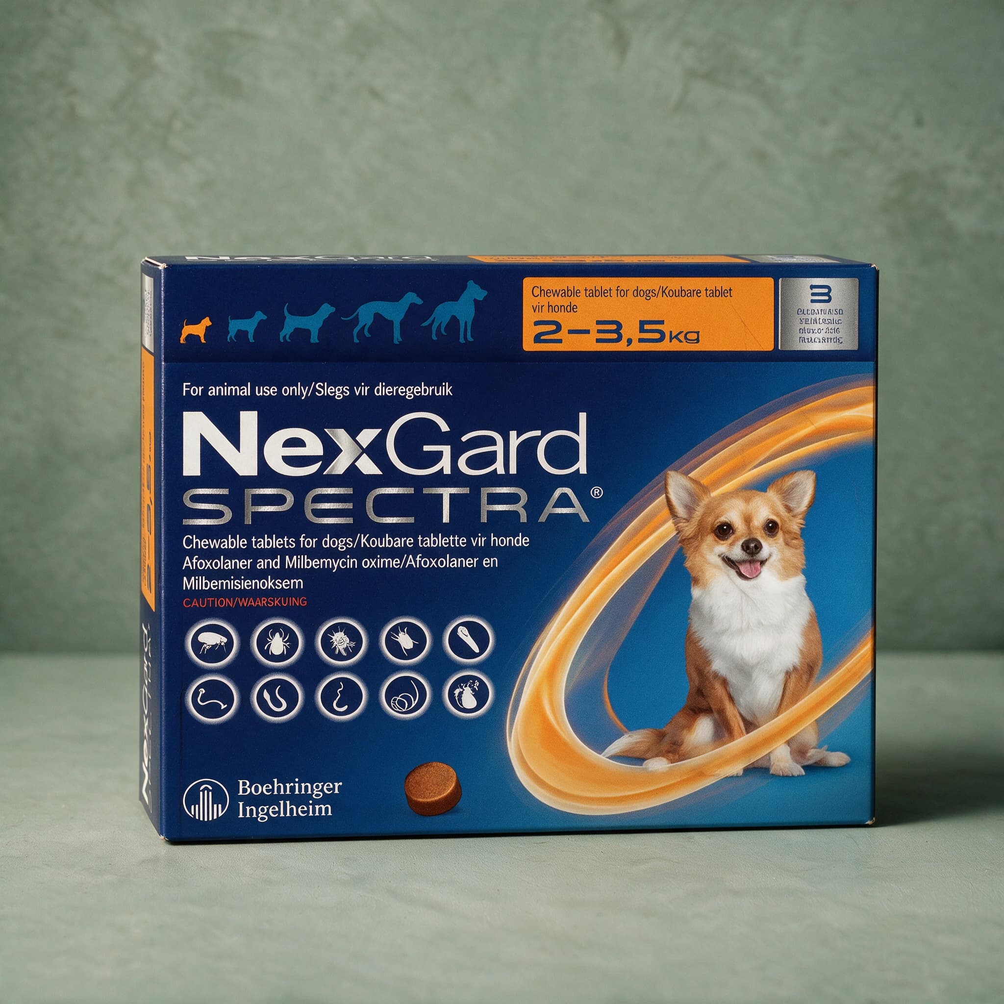 Orange and navy box of NexGard Spectra Chewable Tablets for Dogs, 2-3.5kg pack, with the NexGard Spectra logo, small tan and white dog picture and flea/tick/worm icon row on the front panel.