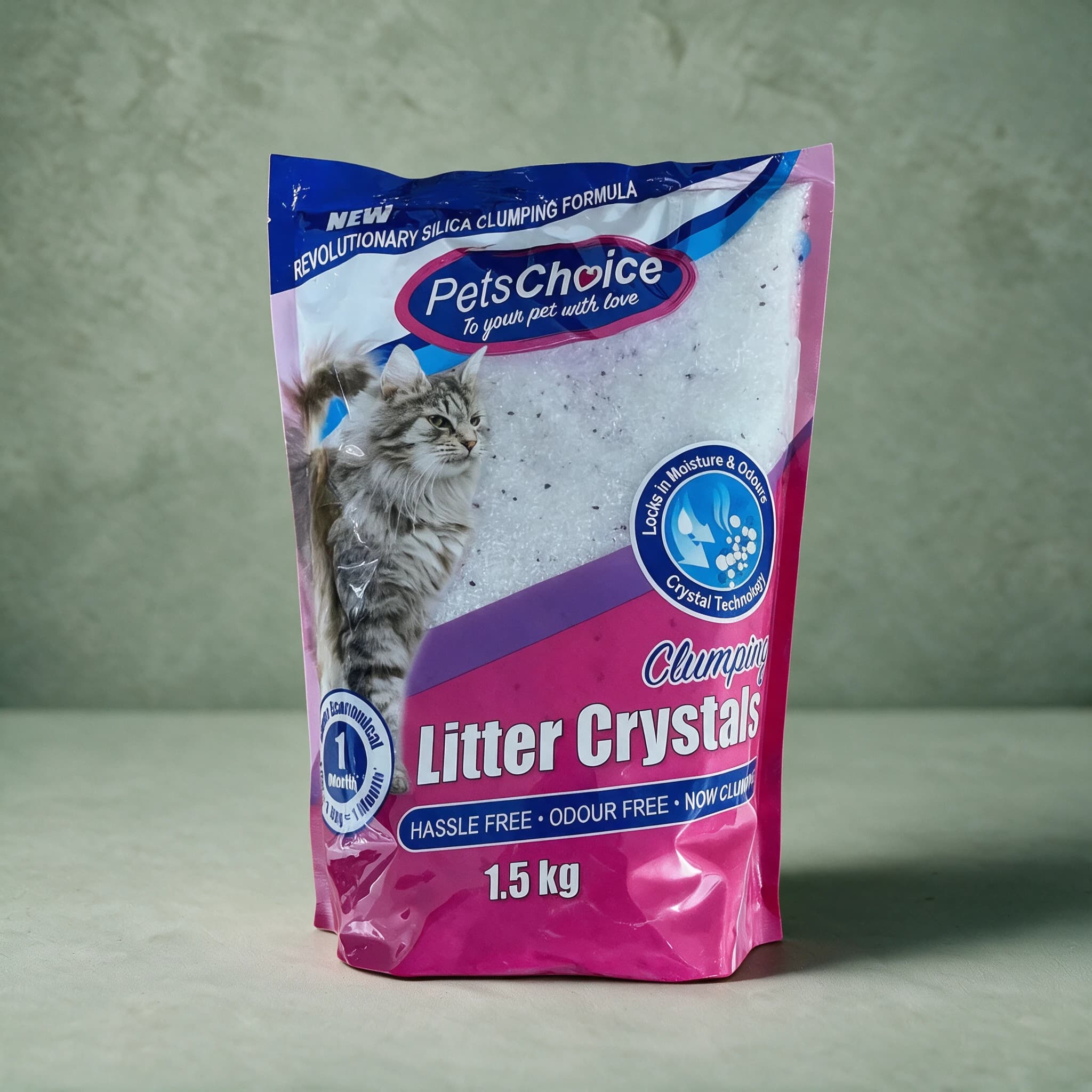 Pink and blue PetsChoice Clumping Litter Crystals bag showing the white silica crystals through a clear window, with a long-haired silver tabby cat, a blue banner reading 'New Revolutionary Silica Clumping Formula'.